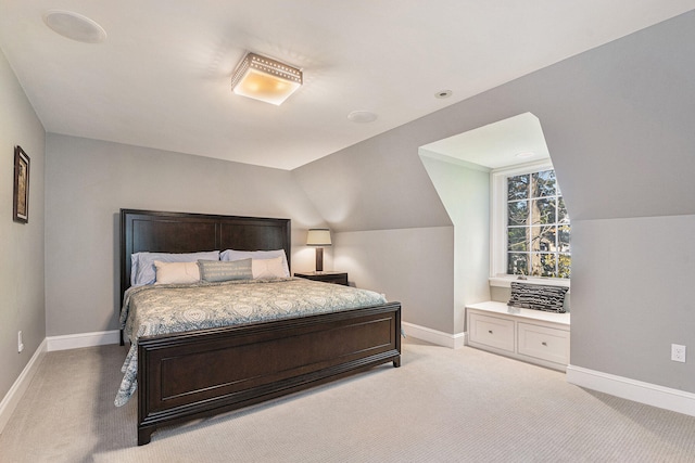 carpeted bedroom with vaulted ceiling