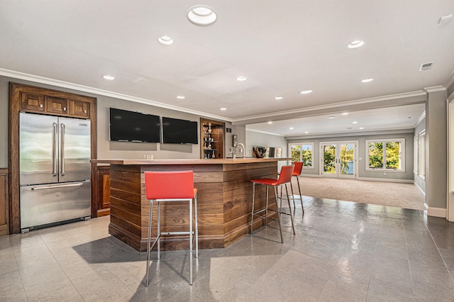 bar with french doors, light tile patterned floors, built in refrigerator, and ornamental molding