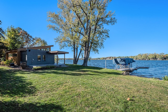 view of dock featuring a yard and a water view