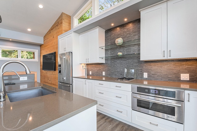 kitchen featuring white cabinetry, sink, a healthy amount of sunlight, stainless steel appliances, and lofted ceiling