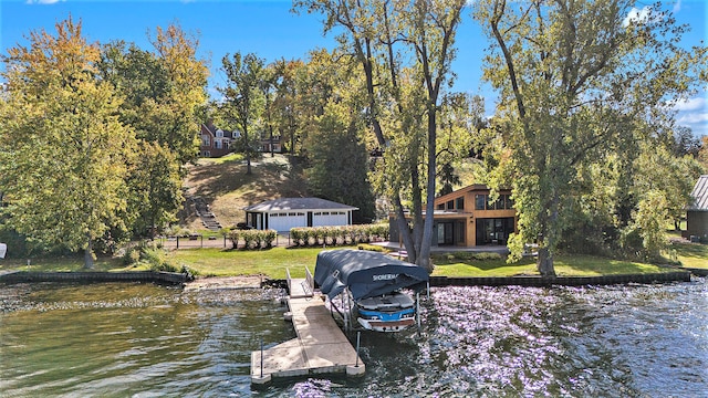 dock area featuring a lawn and a water view