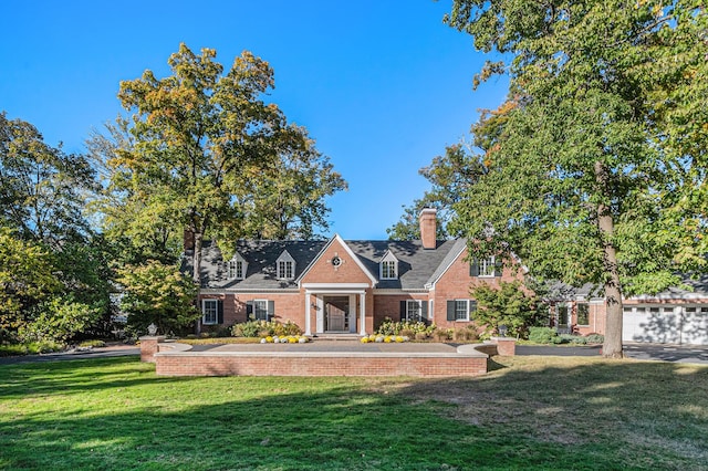 view of front of home with a front lawn and a garage