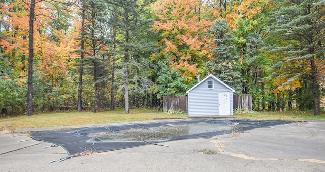 exterior space with a shed and a lawn