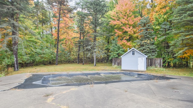 exterior space with a lawn and a storage unit