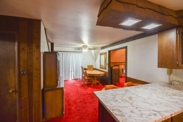 kitchen with ceiling fan and carpet