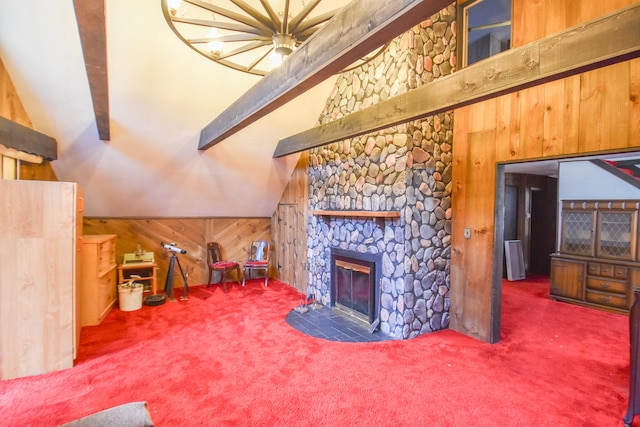 carpeted living room with lofted ceiling with beams, a fireplace, and wood walls