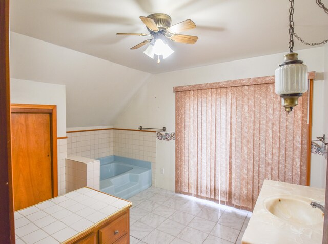 bathroom featuring ceiling fan, vanity, a bathing tub, and tile patterned flooring