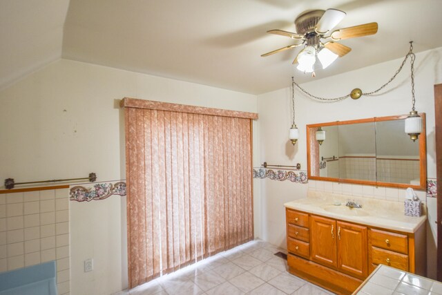 bathroom featuring ceiling fan, vanity, tile patterned flooring, and tasteful backsplash