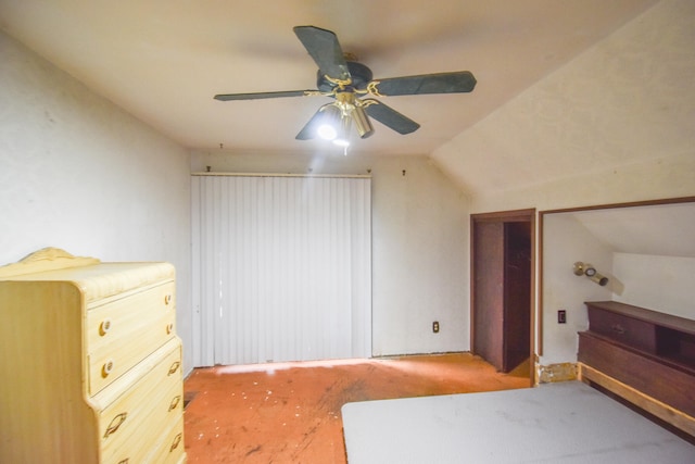 unfurnished bedroom featuring ceiling fan, vaulted ceiling, and carpet