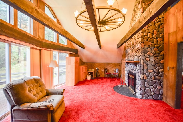 living room with a stone fireplace, wood walls, carpet flooring, and high vaulted ceiling