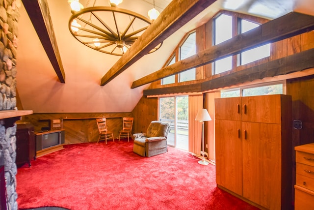 sitting room featuring wooden walls, vaulted ceiling with beams, and carpet floors