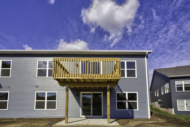 back of property featuring a patio and a balcony