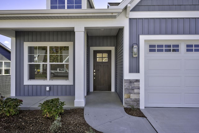 view of exterior entry with a garage