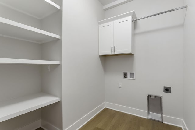 washroom with hookup for a washing machine, hookup for an electric dryer, dark hardwood / wood-style floors, and cabinets