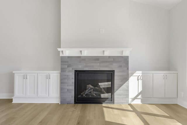 details featuring a brick fireplace and wood-type flooring