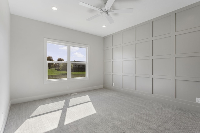 carpeted empty room featuring ceiling fan