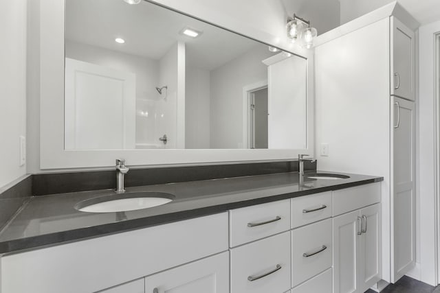 bathroom with vanity and a shower