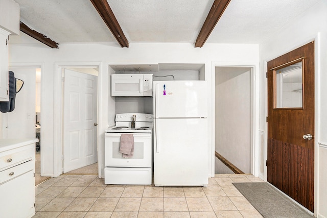 kitchen featuring beamed ceiling, white appliances, light tile patterned floors, and a textured ceiling