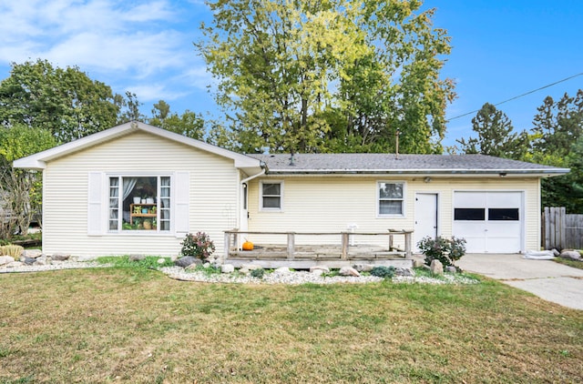 back of house with a garage and a lawn