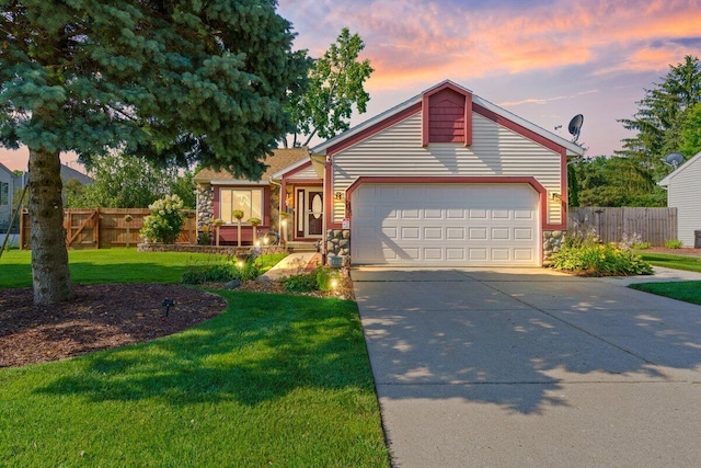 view of front facade with a garage and a lawn