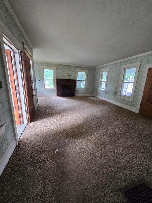 unfurnished living room with carpet, crown molding, and a textured ceiling