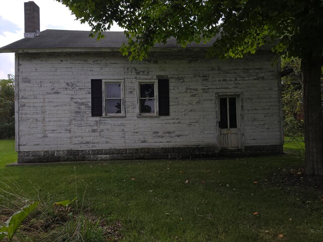 view of side of home featuring a lawn