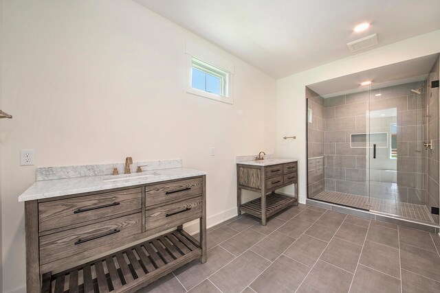 bathroom featuring vanity, tile patterned floors, and walk in shower