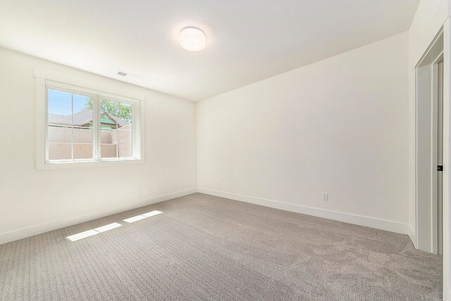 empty room featuring light carpet