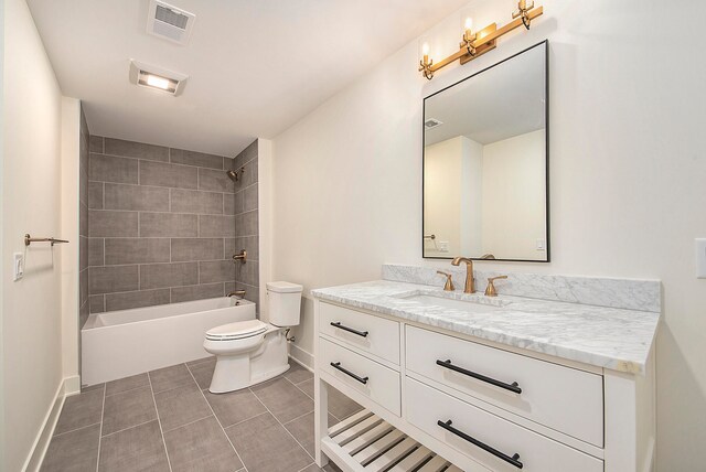 full bathroom with vanity, tiled shower / bath combo, toilet, and tile patterned floors