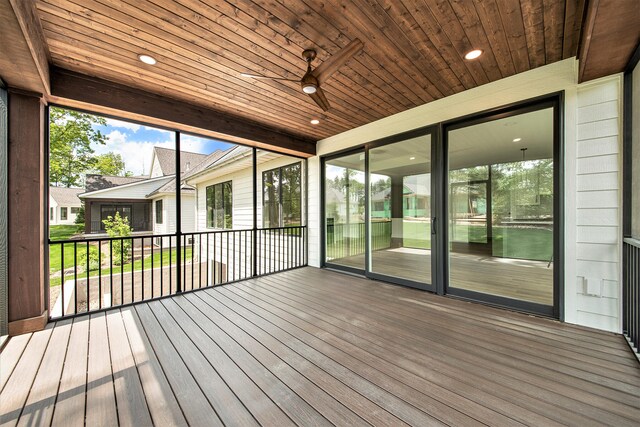 unfurnished sunroom featuring wood ceiling and ceiling fan