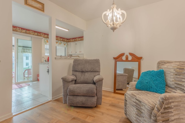 sitting room featuring a chandelier and light hardwood / wood-style flooring