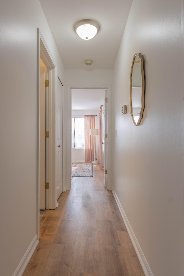 hall with wood-type flooring