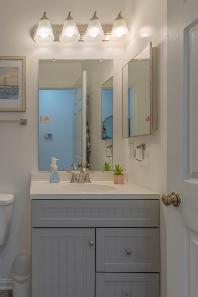 bathroom featuring vanity and toilet