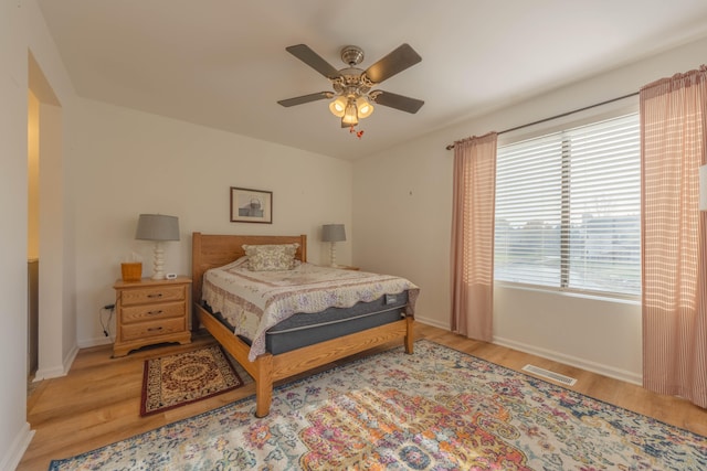 bedroom with light wood-type flooring and ceiling fan