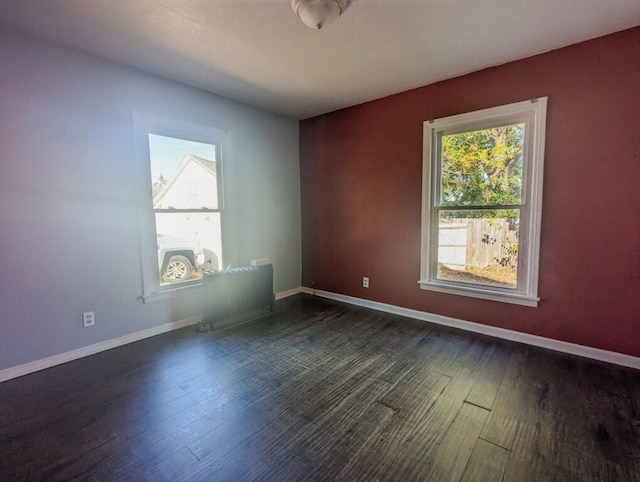 unfurnished room featuring dark hardwood / wood-style floors