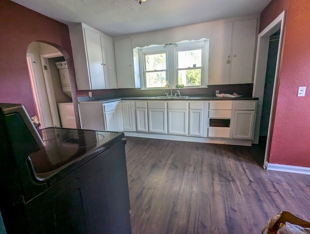 kitchen featuring dark hardwood / wood-style floors, white cabinets, stainless steel refrigerator, sink, and electric range oven