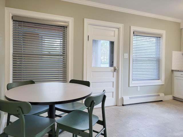 dining area featuring crown molding and a baseboard heating unit