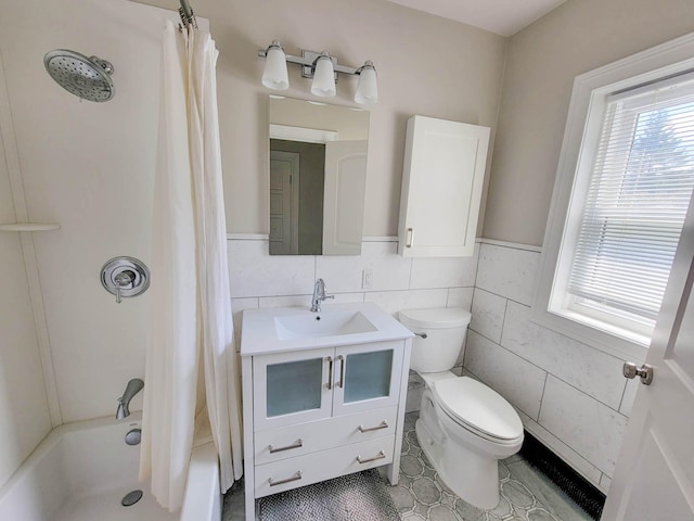 full bathroom with vanity, shower / bath combo with shower curtain, tile walls, tile patterned flooring, and toilet