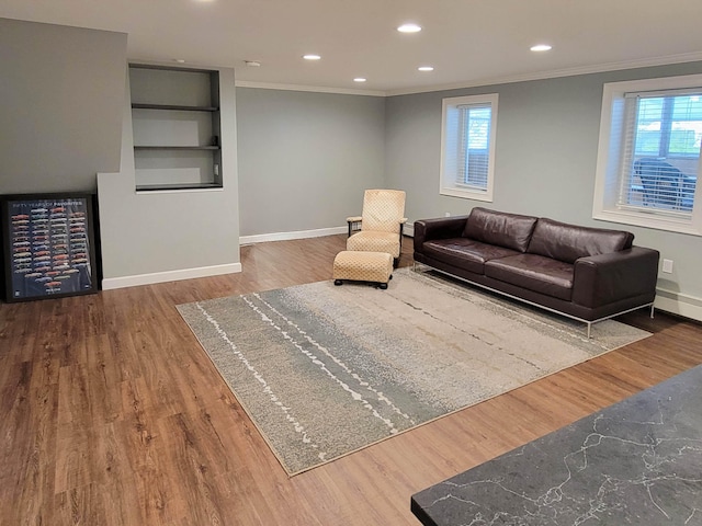 living room featuring ornamental molding and hardwood / wood-style floors