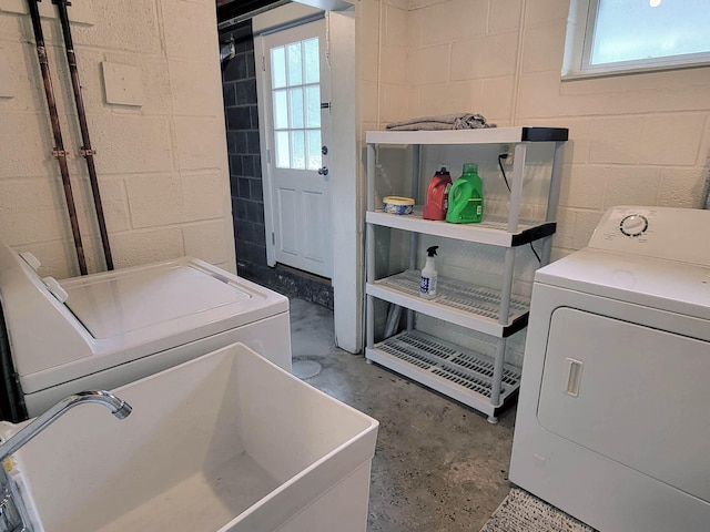 laundry area with washing machine and dryer and sink