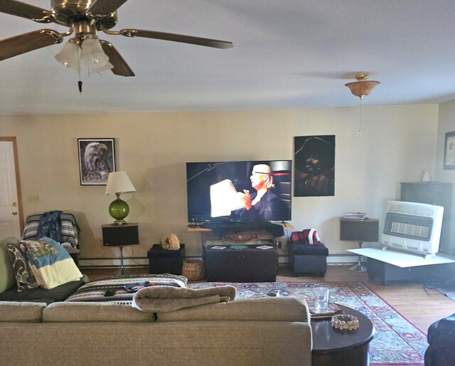 living room with ceiling fan, heating unit, baseboard heating, and wood-type flooring