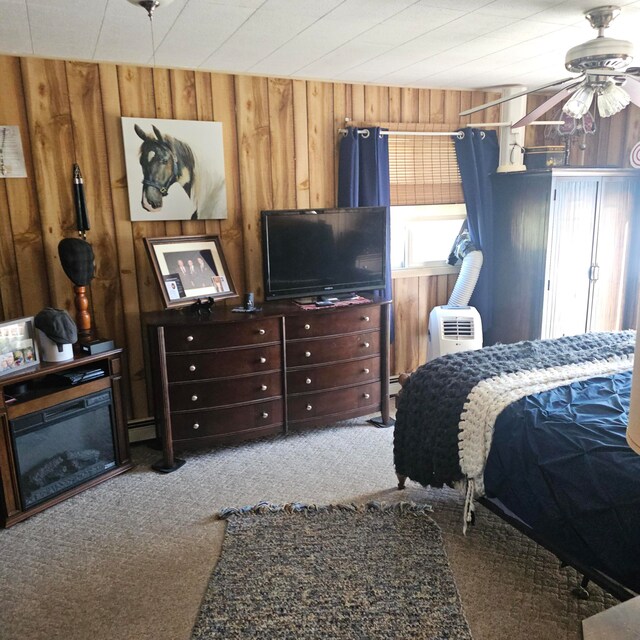 carpeted bedroom with wooden walls and ceiling fan