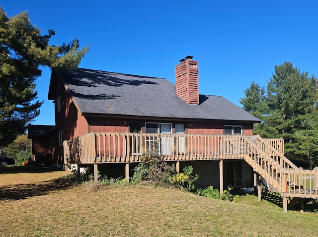 back of property with a deck and a lawn