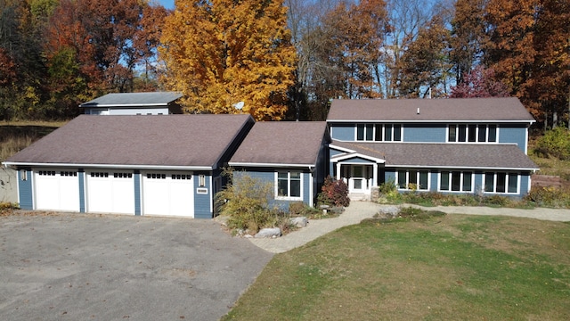 view of front property featuring a front yard and a garage