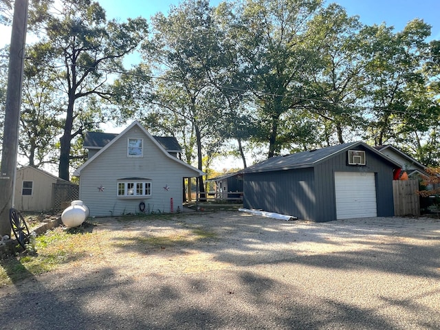 view of property exterior with a garage and an outbuilding