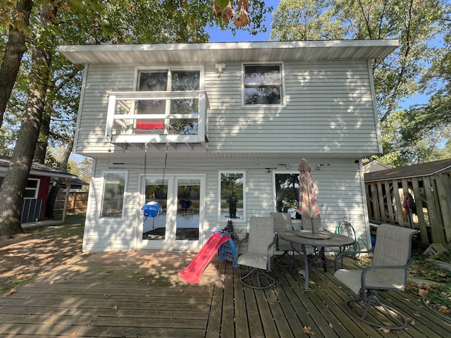 back of house featuring a wooden deck