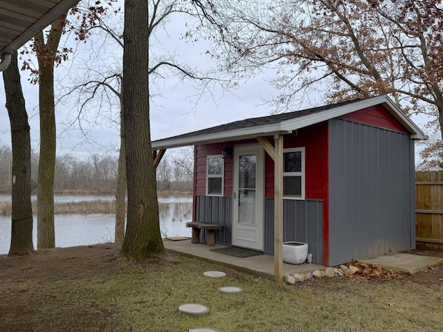 view of outdoor structure with a yard and a water view