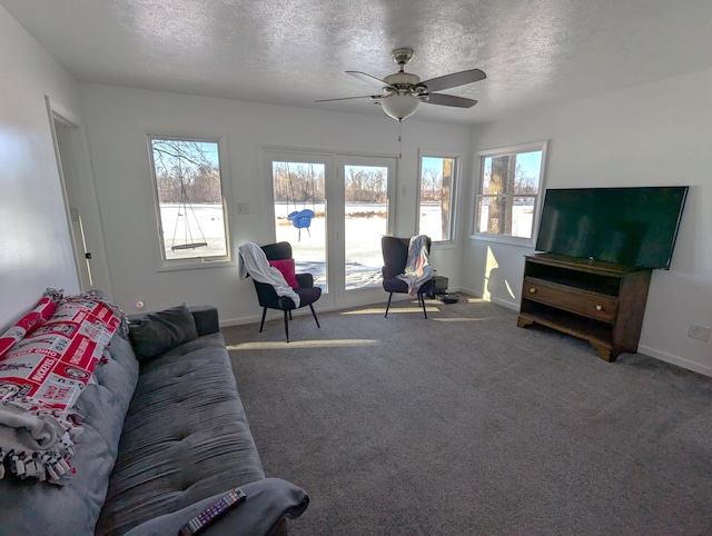 living room with ceiling fan, a textured ceiling, and carpet flooring