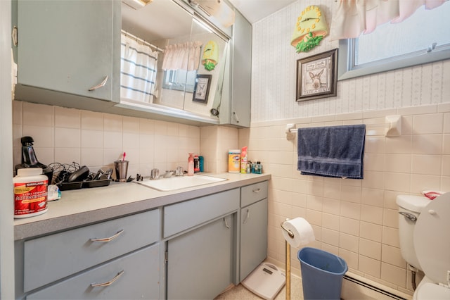 bathroom featuring a wealth of natural light, tile walls, vanity, and toilet