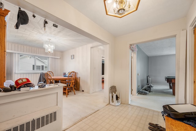 interior space with an inviting chandelier, pool table, carpet flooring, and radiator heating unit